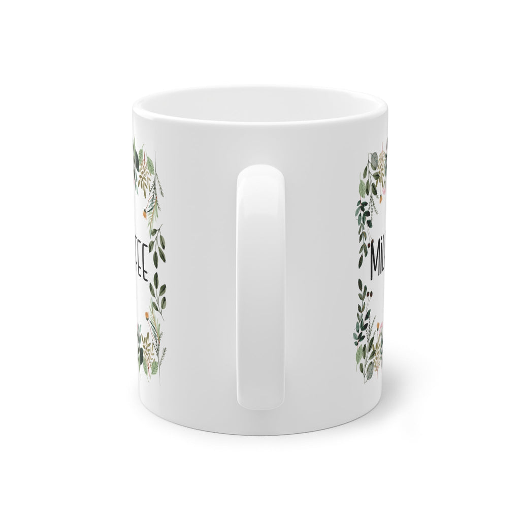 a white mug with a floral design on it