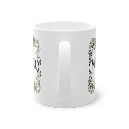 a white mug with a floral design on it