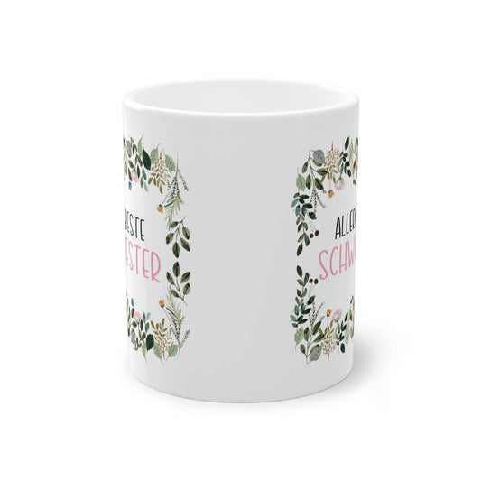 a white coffee mug with a wreath on it