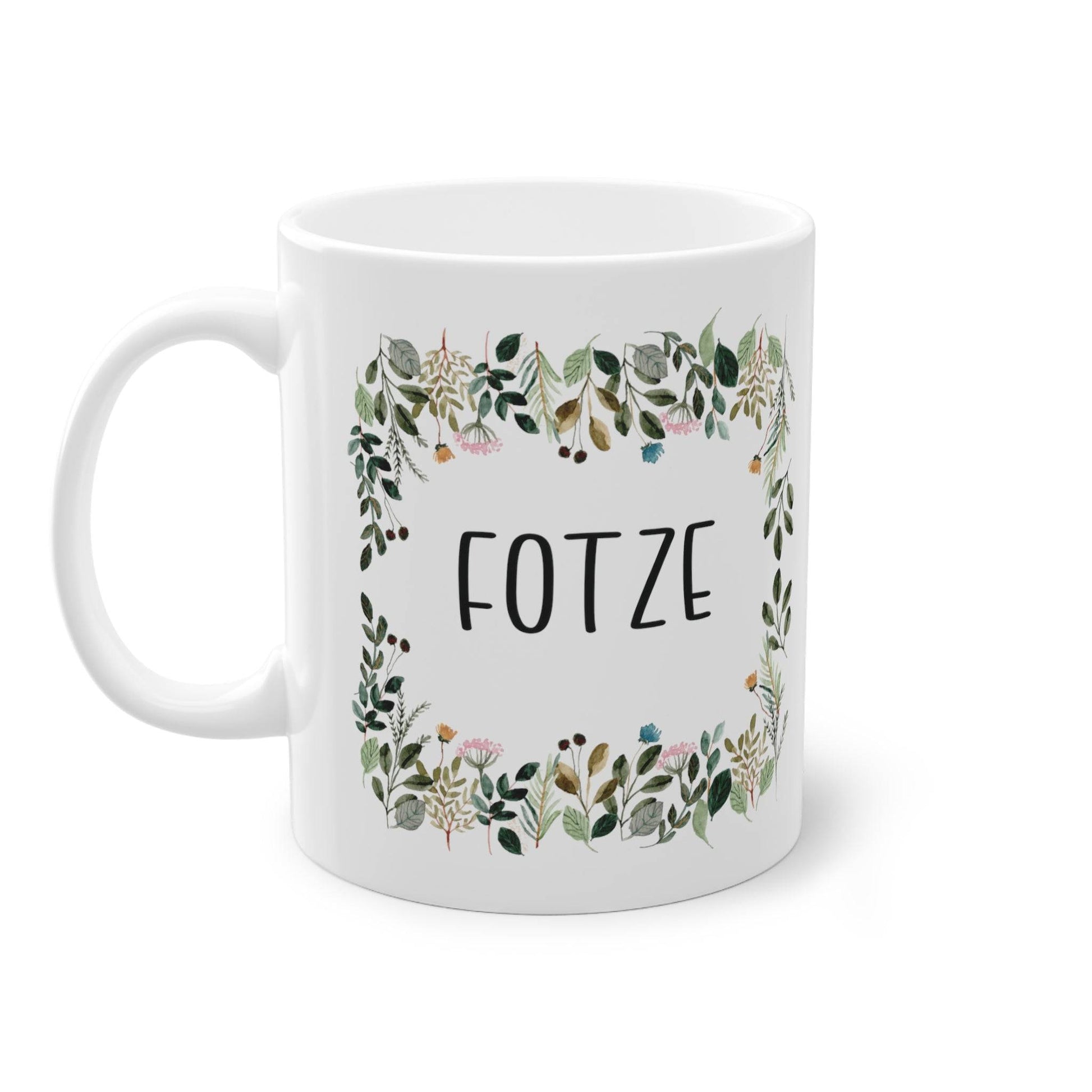 a white coffee mug with a floral frame on it