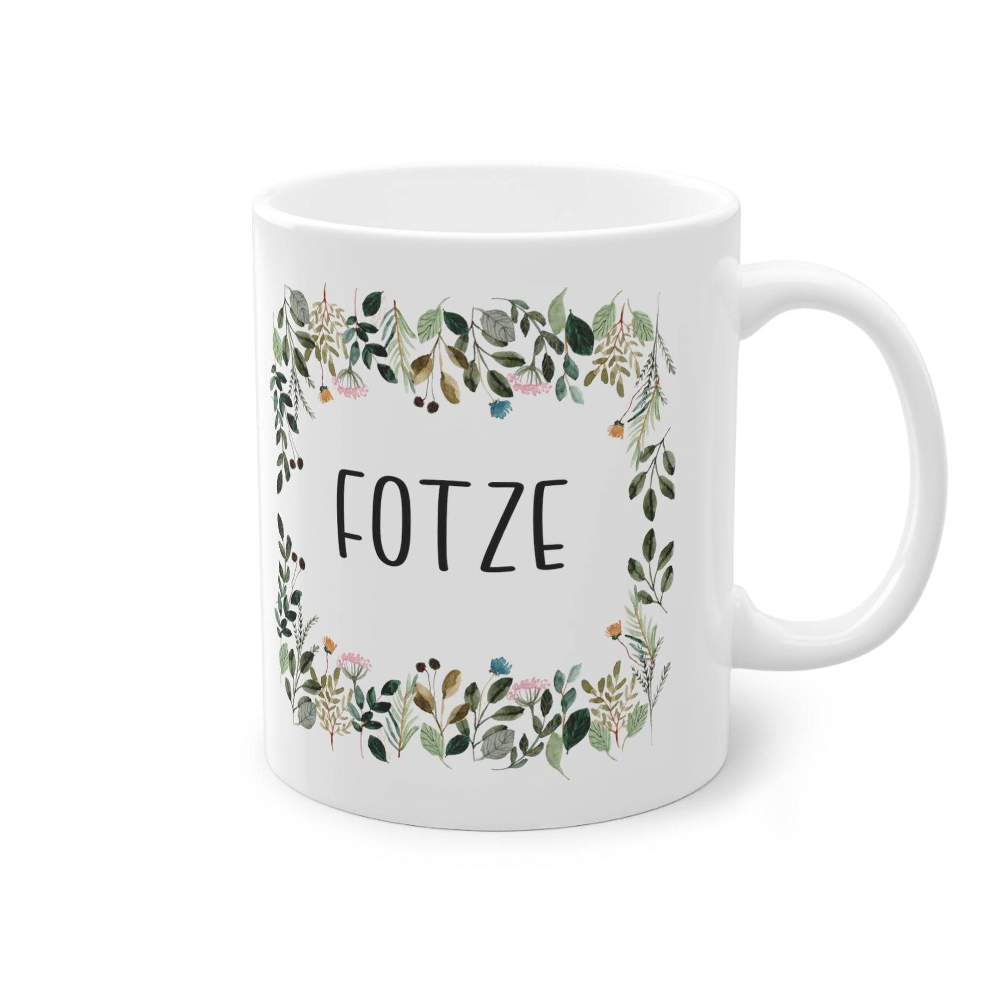 a white coffee mug with a floral frame on it