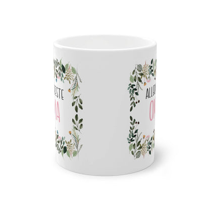 a white mug with a floral design on it