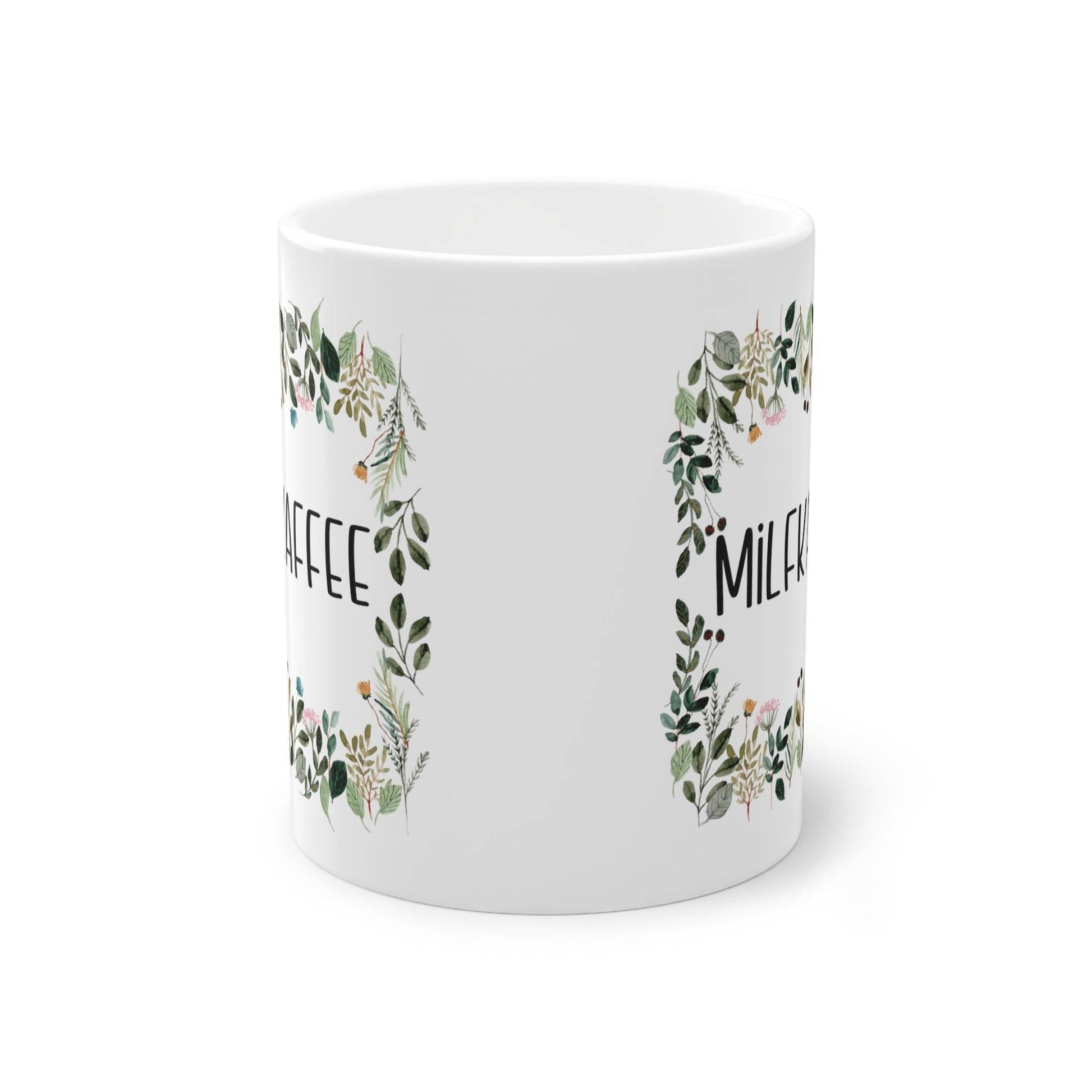 a white coffee mug with a floral design
